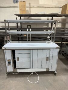 Mobile hot cupboard, front view with sliding doors and two-tier heated gantry above