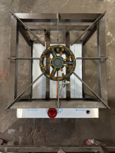 Gas stockpot cooker, top-down view of the cast ring burner in its square stainless stand